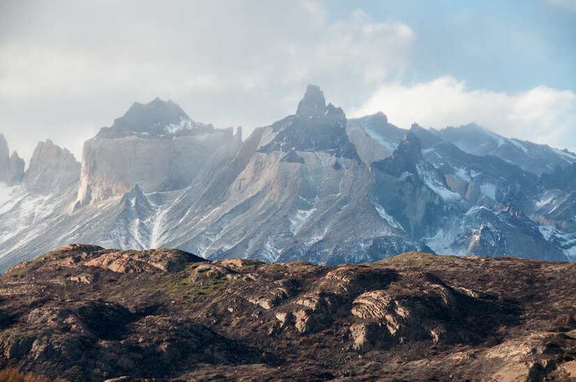 A scenic view of a travel agency Himalayan surrounded by lush greenery and snow-capped mountains in Himachal Pradesh, India.