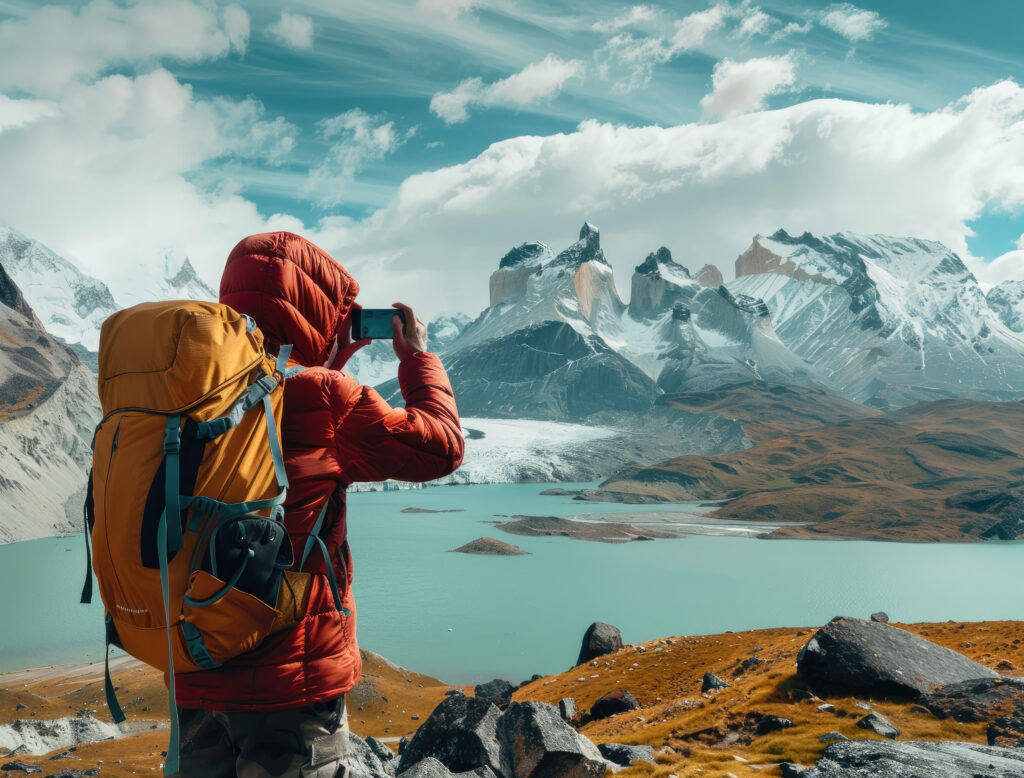 Solo traveler photographing snow peaks and lakes in Himachal.