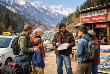 Travel agent in Manali explaining trekking and adventure tour options to tourists near a mountain river.